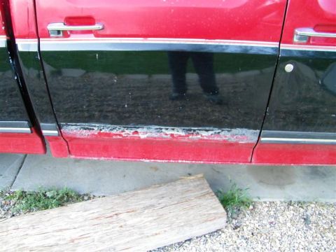 1990 Ford F-350 - Rust is visible on the lower trim of this red and black 1990 Ford F-350 crew cab truck door.