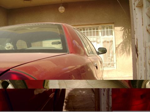 1998 Ford Crown Victoria - Rear quarter view of a red 1998 Ford Crown Victoria parked outdoors.
