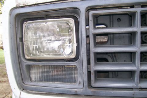 1982 Ford E350 - Close-up of the front grille and headlight assembly on a 1982 Ford E350 van.