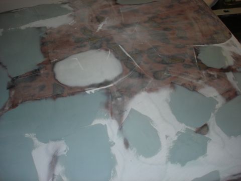 1979 Ford F-250 - Body filler and primer applied to a vehicle hood undergoing repair.