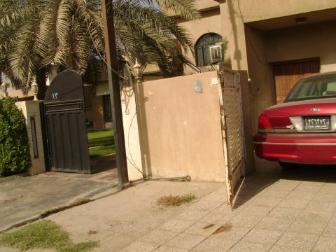 1998 Ford Crown Victoria - Rear view of a red sedan with a license plate visible.