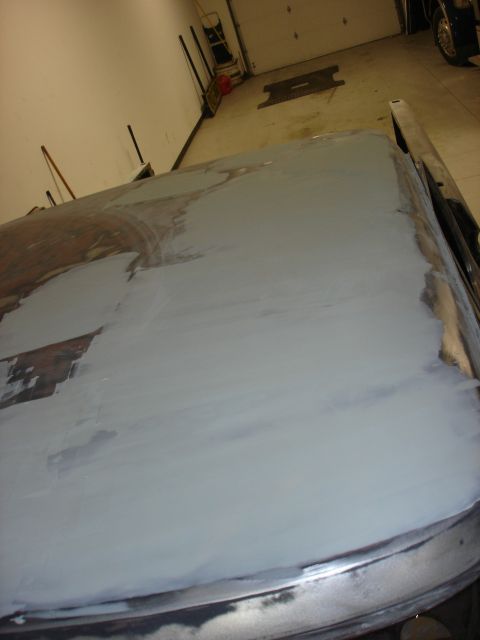 1979 Ford F-250 - Body filler applied to a car hood during a repair process.