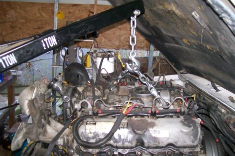 1992 Ford C-350 (Centurion Conversions) - Engine removal in progress with a 1-ton engine hoist.