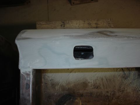 1979 Ford F-250 - A close-up view shows a vehicle door panel, likely undergoing repair or modification, with a rectangular cutout.