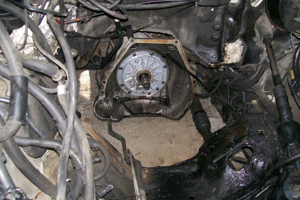 Engine bay of a truck with engine removed showing bellhousing