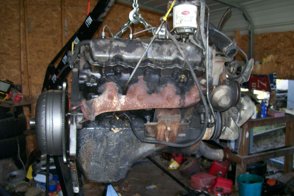 Engine and transmission assembly being lifted by an engine hoist