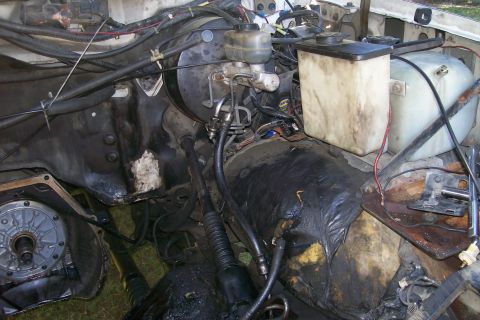 1992 Ford C-350 (Centurion Conversions) - The engine bay shows various components including the master cylinder, brake booster, and fluid reservoirs, with some transmission parts vi…