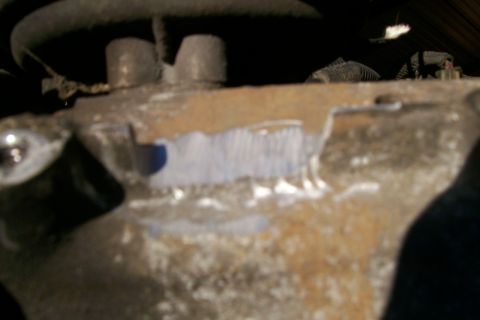 1992 Ford C-350 (Centurion Conversions) - A close-up view of a corroded engine part with visible markings.