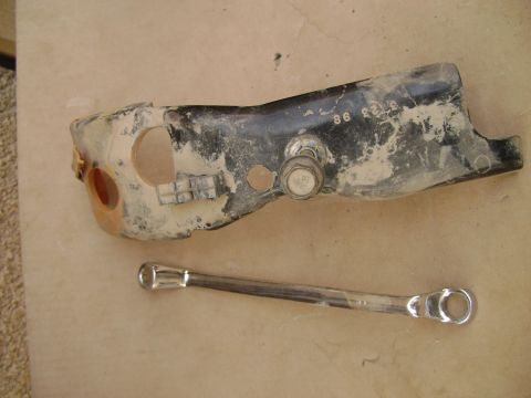 1998 Ford Crown Victoria - A dirty automotive part, possibly from a 1998 vehicle, is shown next to a wrench. Numbers '86 23 98' are visible on the part.