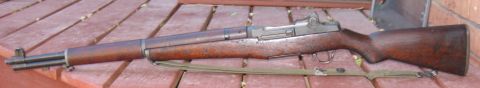 2000 Ford Crown Victoria - A side view of an M1 Garand rifle with a canvas sling.