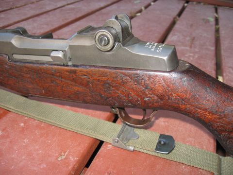 2000 Ford Crown Victoria - Close-up view of an M1 Garand rifle's receiver and wooden stock.