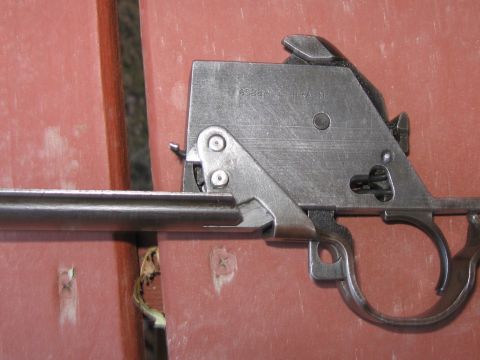 2000 Ford Crown Victoria - A close-up view of a gun's trigger mechanism, showing intricate metalwork and patent markings.