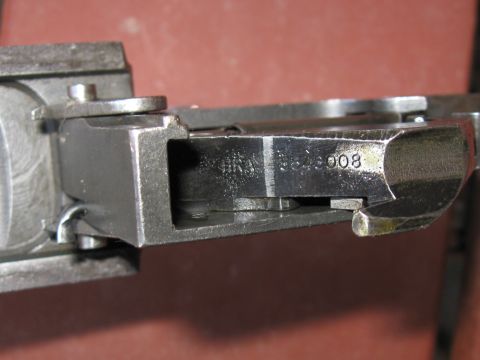 2000 Ford Crown Victoria - Metal component showing a stamped serial number, likely a part from machinery.