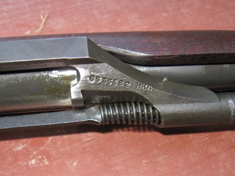 2000 Ford Crown Victoria - A close-up view of a gun's receiver, revealing a serial number and internal components.