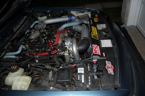 1985 Mercury Grand Marquis - The engine bay features a turbocharger setup with custom piping and performance ignition parts.