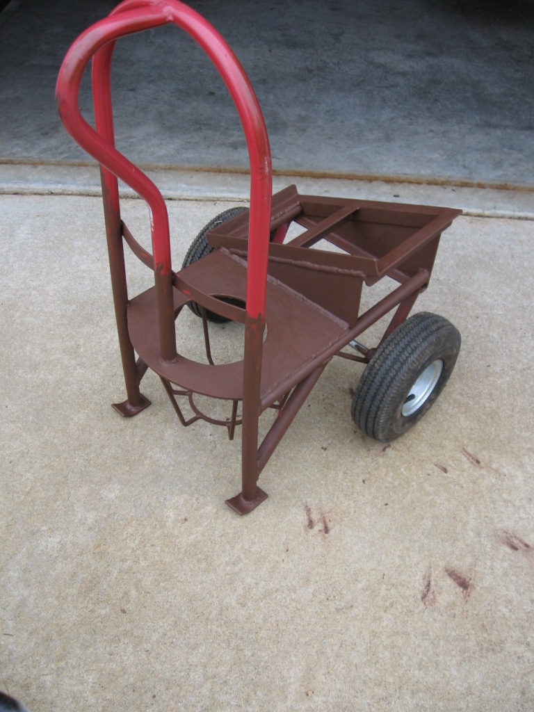 Red and brown welding cart with two wheels