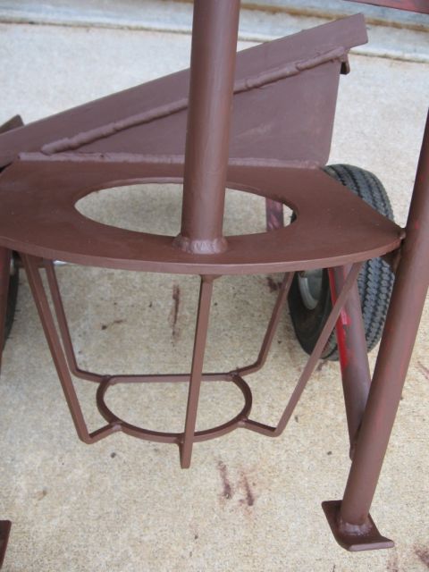 1995 Ford F-150 - Close-up of a metal welding cart, showing its construction and a wheel.