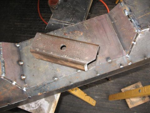 1995 Ford F-150 - A close-up view of a welded metal frame part, showing construction details and a central hole.