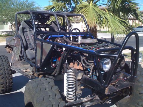 1966 Ford Bronco - Custom off-road buggy features a prominent roll cage and exposed engine components.