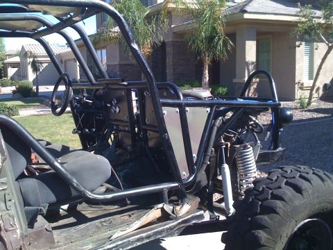 1966 Ford Bronco - This custom off-road vehicle features a prominent roll cage and exposed suspension system.
