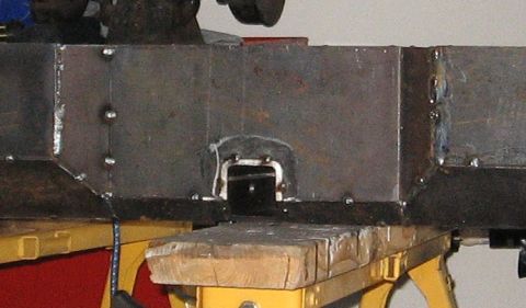 1995 Ford F-150 - Close-up view of a fabricated metal bumper component, showing welding details and a central receiver hitch opening.