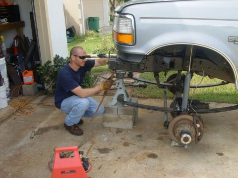 1995 Ford Bronco - Mike cutting off hangers so new 1" longer hanger can be welded on.