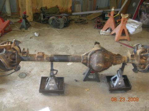 1991 Ford F-150 - Rear axle assembly supported by jack stands in a garage setting.