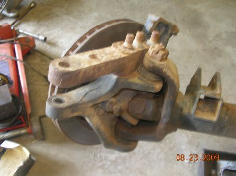 1991 Ford F-150 - Front axle assembly with brake rotor and suspension components, likely from a truck.