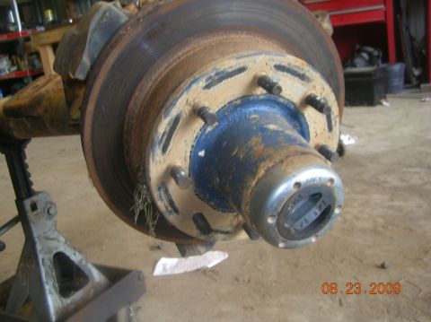 1991 Ford F-150 - This image shows a close-up of a vehicle's hub and brake rotor assembly, supported by a jack stand.