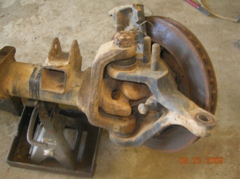 1991 Ford F-150 - This image shows a rusty front axle assembly with a brake rotor, likely from a truck or SUV.