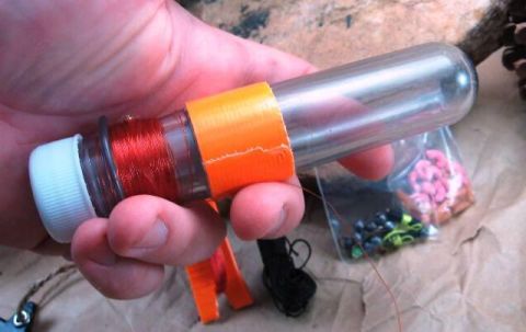 1991 Ford Bronco - Supplies for tying fishing lures, including thread and various lure components.