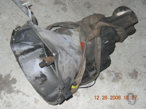 1991 Ford F-150 - A transmission part is shown secured with straps on a concrete surface, with a timestamp of 12.26.2006.