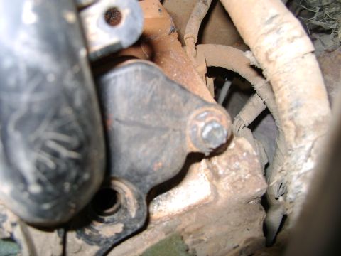 1998 Ford Crown Victoria - Close-up view of an engine component with a bolt and surrounding wiring.