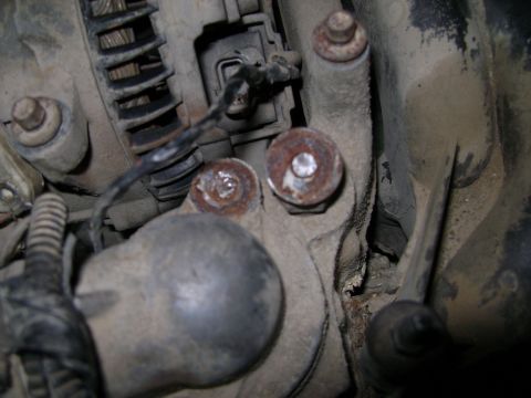 1998 Ford Crown Victoria - Detail of an engine component, showing bolts and electrical connections.