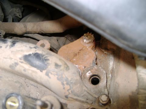 1998 Ford Crown Victoria - This image shows a close-up view of a rusty engine part, possibly related to the intake system.