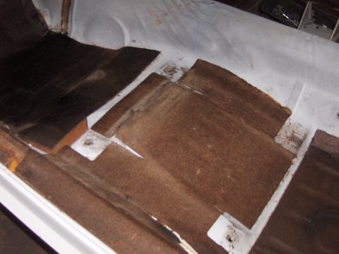 1970 Chevrolet Camaro - The interior floor pan of a vehicle, showing removed sound deadening material and exposed metal.
