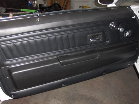 1970 Chevrolet Camaro - Interior door panel of a 1970 Chevrolet Camaro, black vinyl and chrome accents.