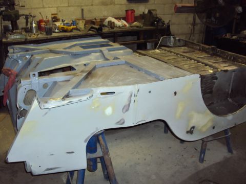 1948 Jeep Wrangler - Body tub of a Jeep CJ in a workshop, showing repair work in progress.