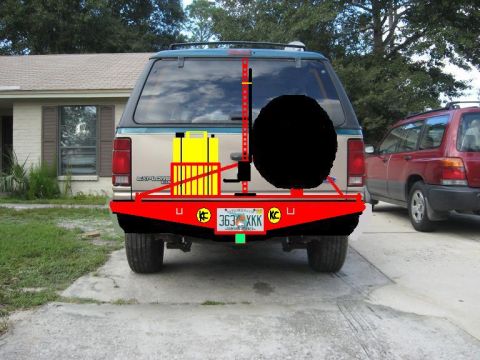 1992 Ford Explorer - Rear view of a 1992 Ford Explorer equipped with a custom red bumper and spare tire carrier, alongside a red SUV.
