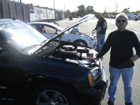 2000 Ford Crown Victoria - Cars and people gathered at a drag strip event with hoods open.