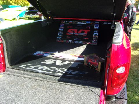 2007 Ford Mustang - Display inside a truck bed SVT Lightning branding and memorabilia.