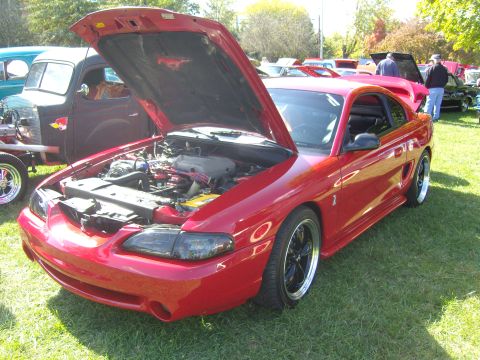 2007 Ford Mustang - A red 1994 Ford Mustang is displayed with its hood open, revealing the engine compartment.