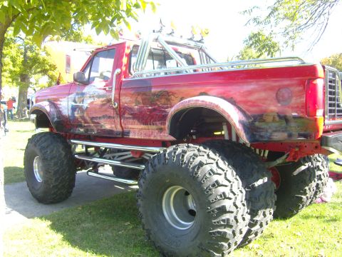 2007 Ford Mustang - Custom lifted pickup truck with extensive body modifications and airbrushed artwork.