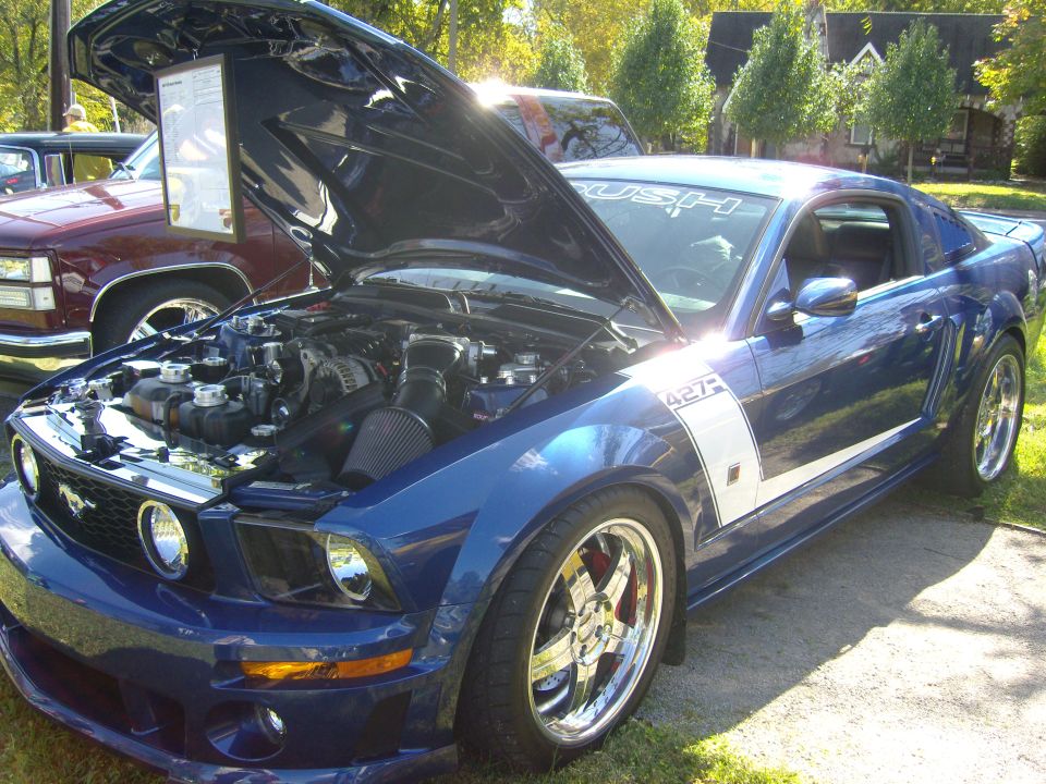 Blue 2007 Ford Mustang 427 with hood open, showing engine and side stripe