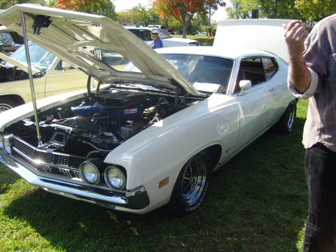 2007 Ford Mustang - White 1970 Ford Torino GT displayed with its hood open, revealing the engine bay.