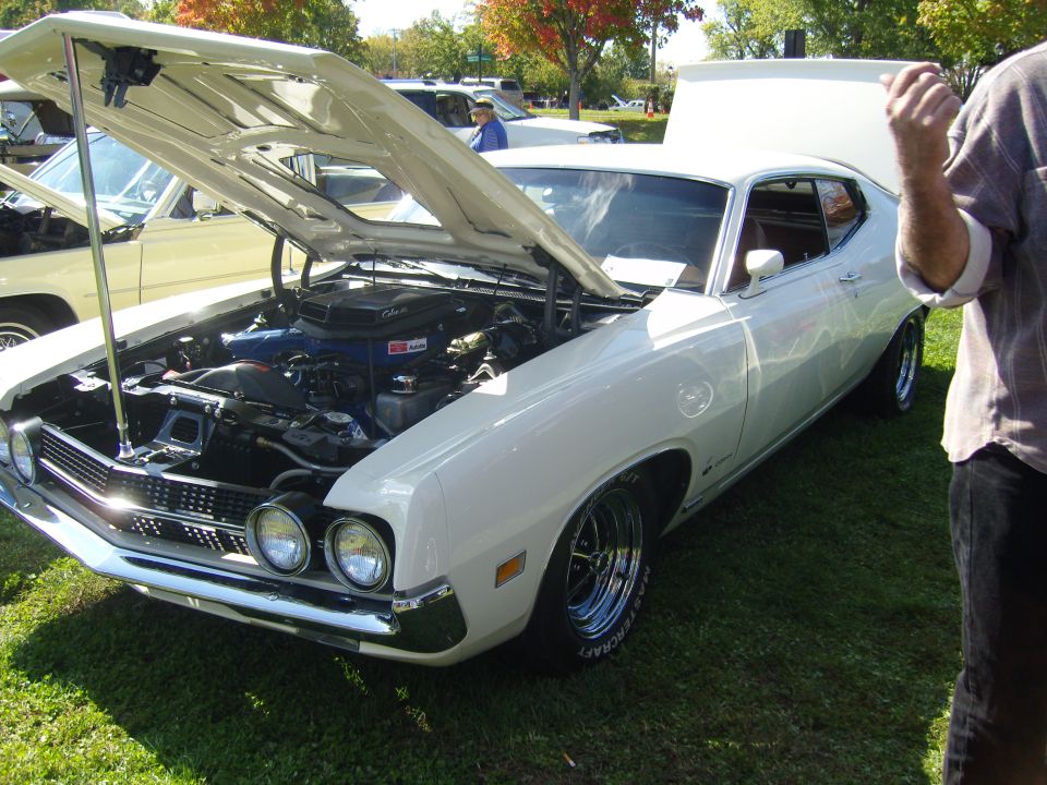White 1970 Ford Torino GT front 3/4 view with hood open