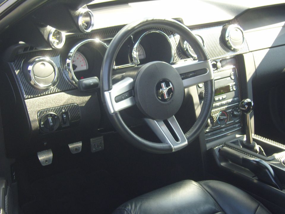 2007 Ford Mustang interior showing dashboard, steering wheel with Mustang logo, and center console with shifter