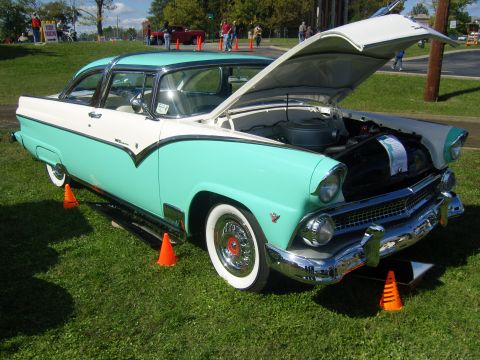2007 Ford Mustang - A classic 1955 Ford Fairlane is displayed with its hood up, the engine bay.