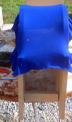 1999 Ford Taurus - Blue fabric draped over a wooden stand, with "SUPERMOTORS.NET" visible at the bottom.