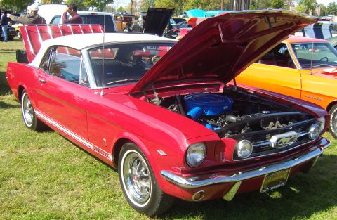 2007 Ford Mustang - Classic red Ford Mustang convertible on display with its engine exposed.